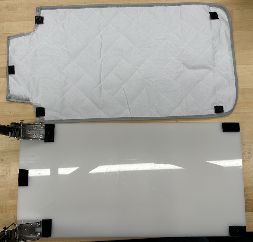 Changing pad and HDPE base laid open, showing the matching velcro tabs along the perimeter